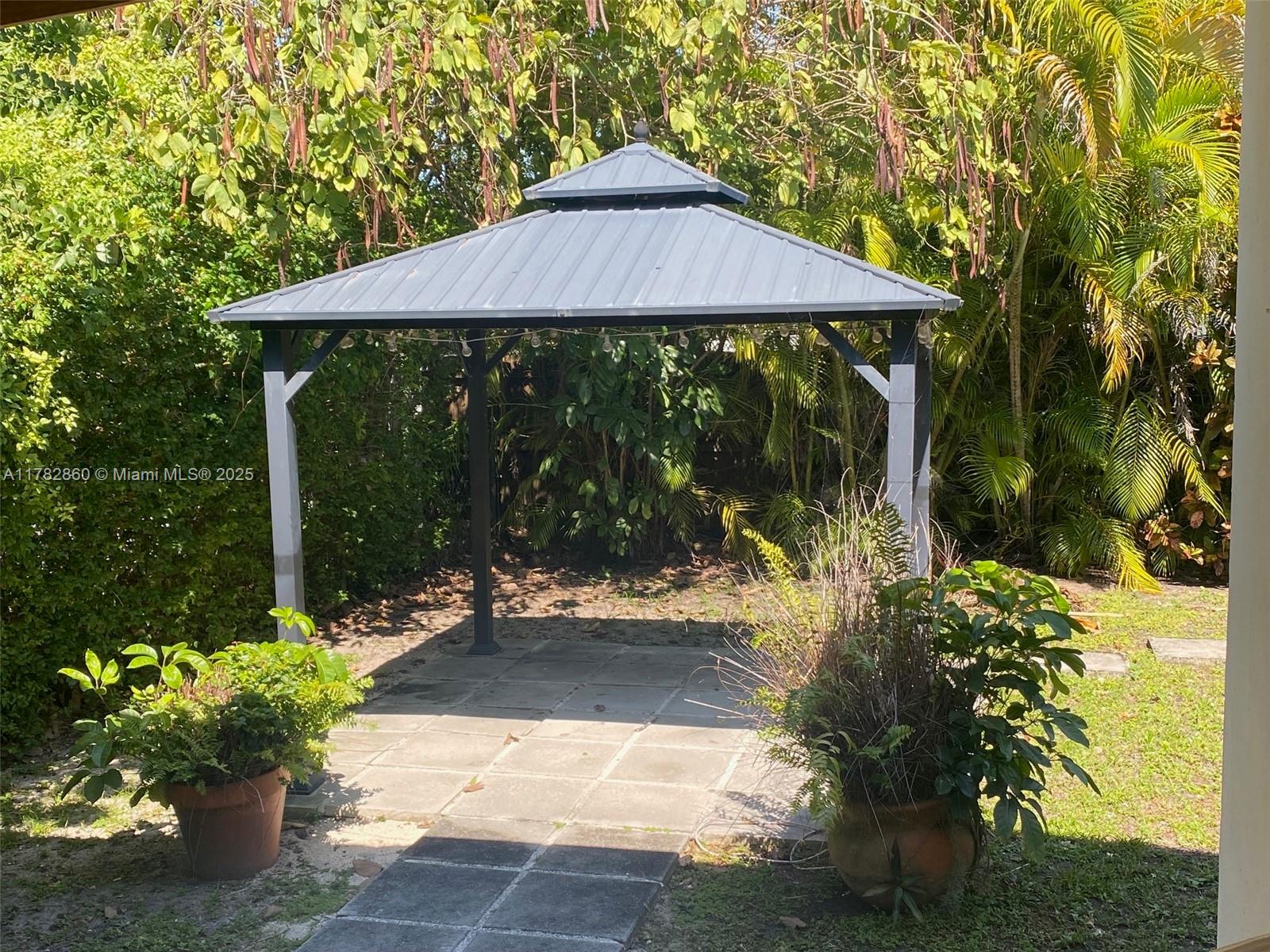 6331 Southwest 17th Street West Miami, FL 33155 - Photo 26 of 42 a patio with table and chairs under an umbrella