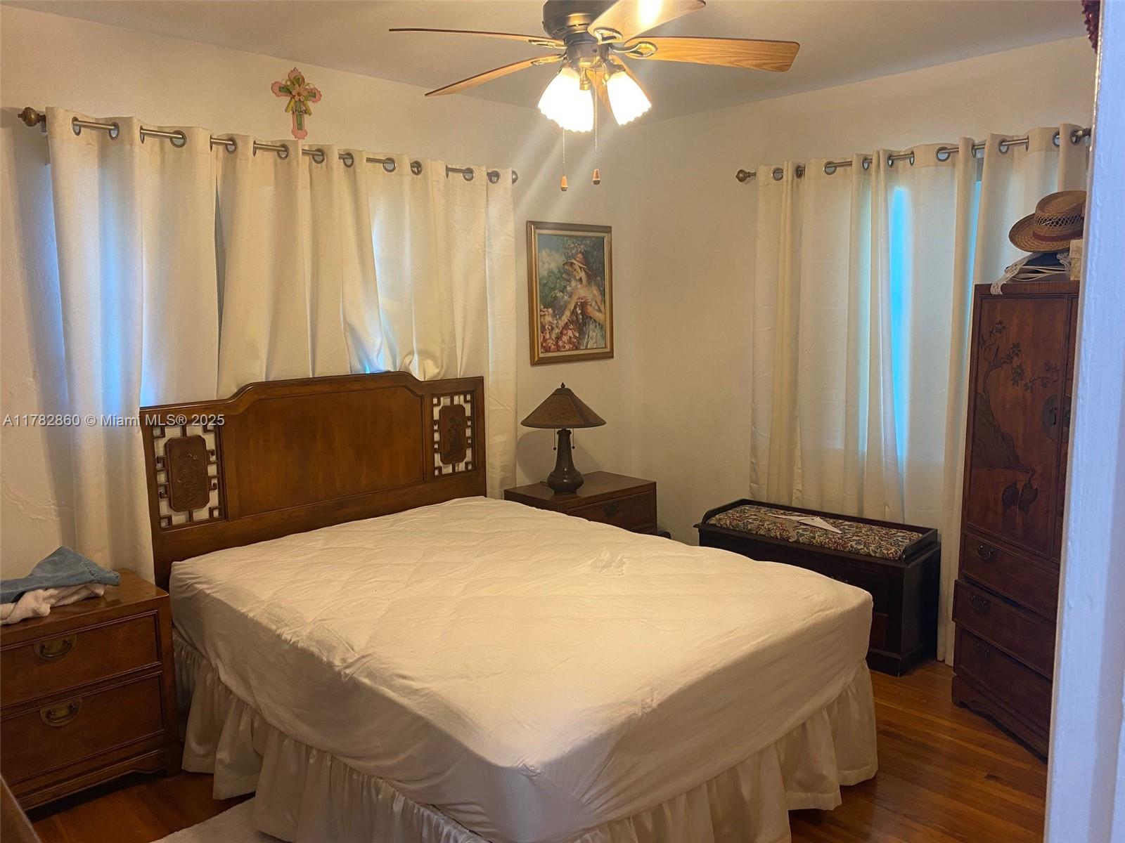 6331 Southwest 17th Street West Miami, FL 33155 - Photo 41 of 42 a bedroom with a bed and a chandelier