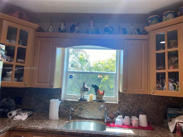 a kitchen with a window and cabinets