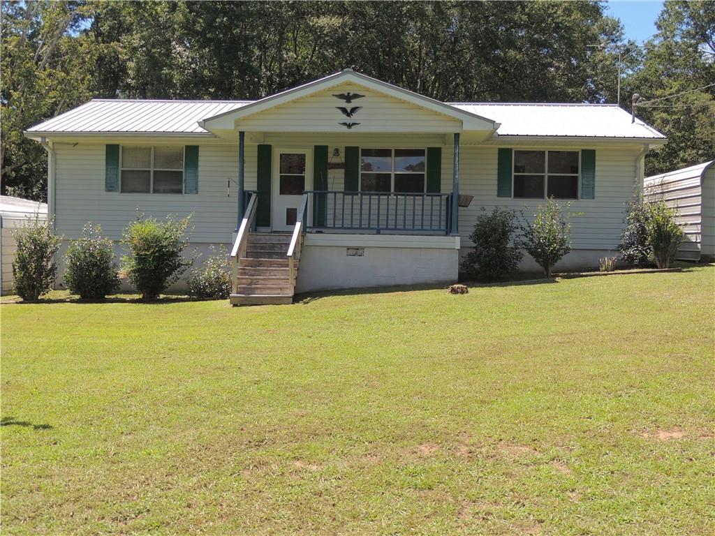 12960 Providence Road Alpharetta, GA 30009 - Photo 1 of 1 a front view of house with yard and swimming pool