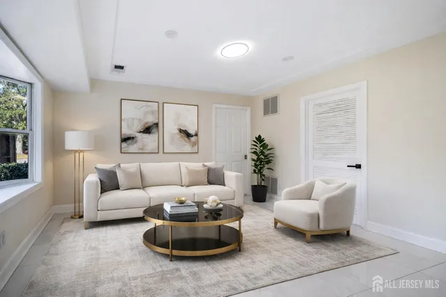 a living room with furniture potted plant and a window