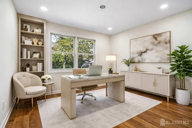 a aerial view of a house with swimming pool and large trees