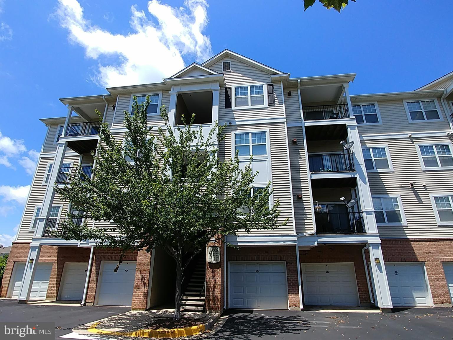 19606 Galway Bay Circle, Unit 302 Germantown, MD 20874 - Photo 1 of 35 a front view of a house with a tree