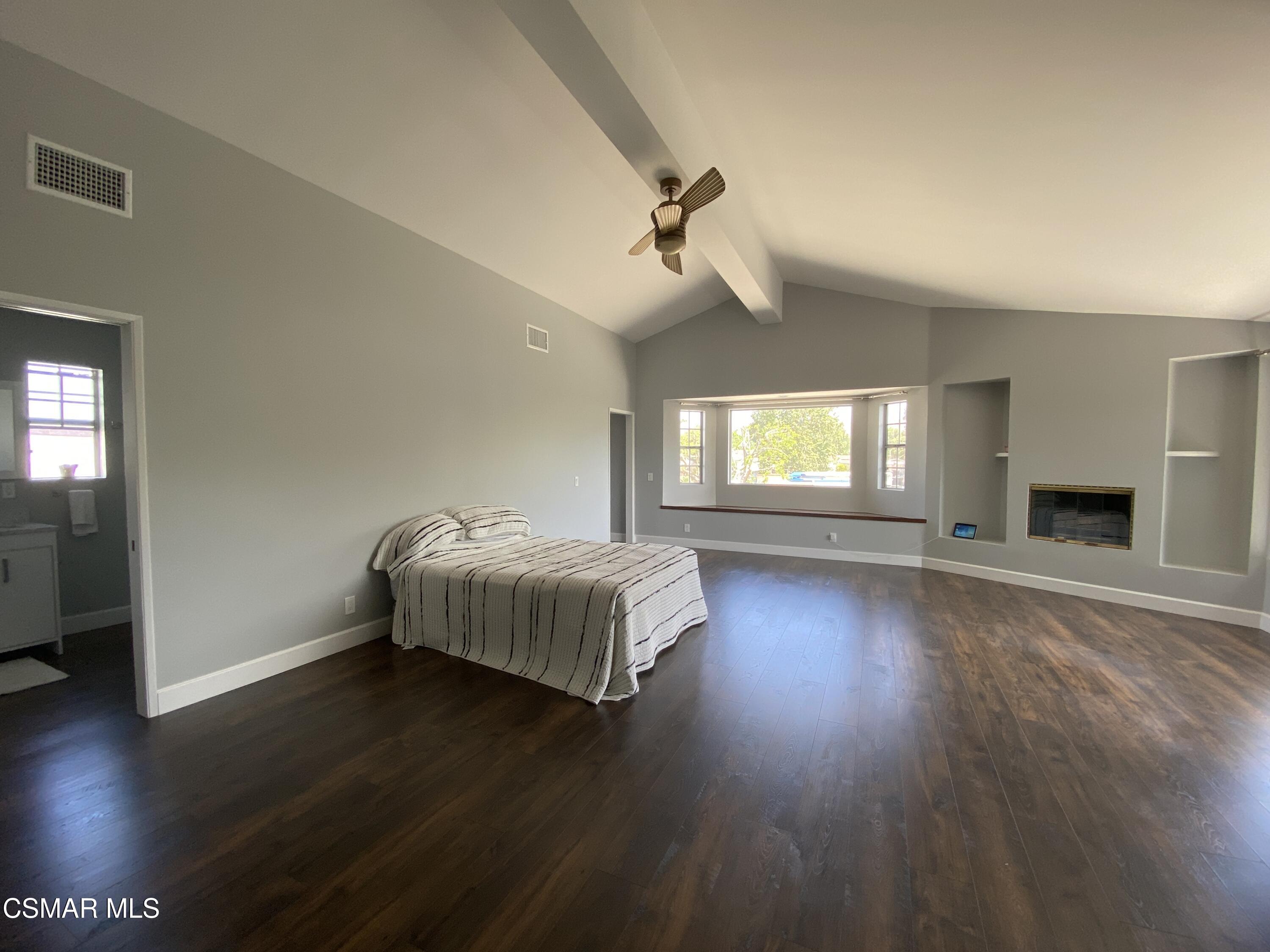 4511 Barnard Street Simi Valley, CA 93063 - Photo 12 of 25 a spacious bedroom with a bed and wooden floor