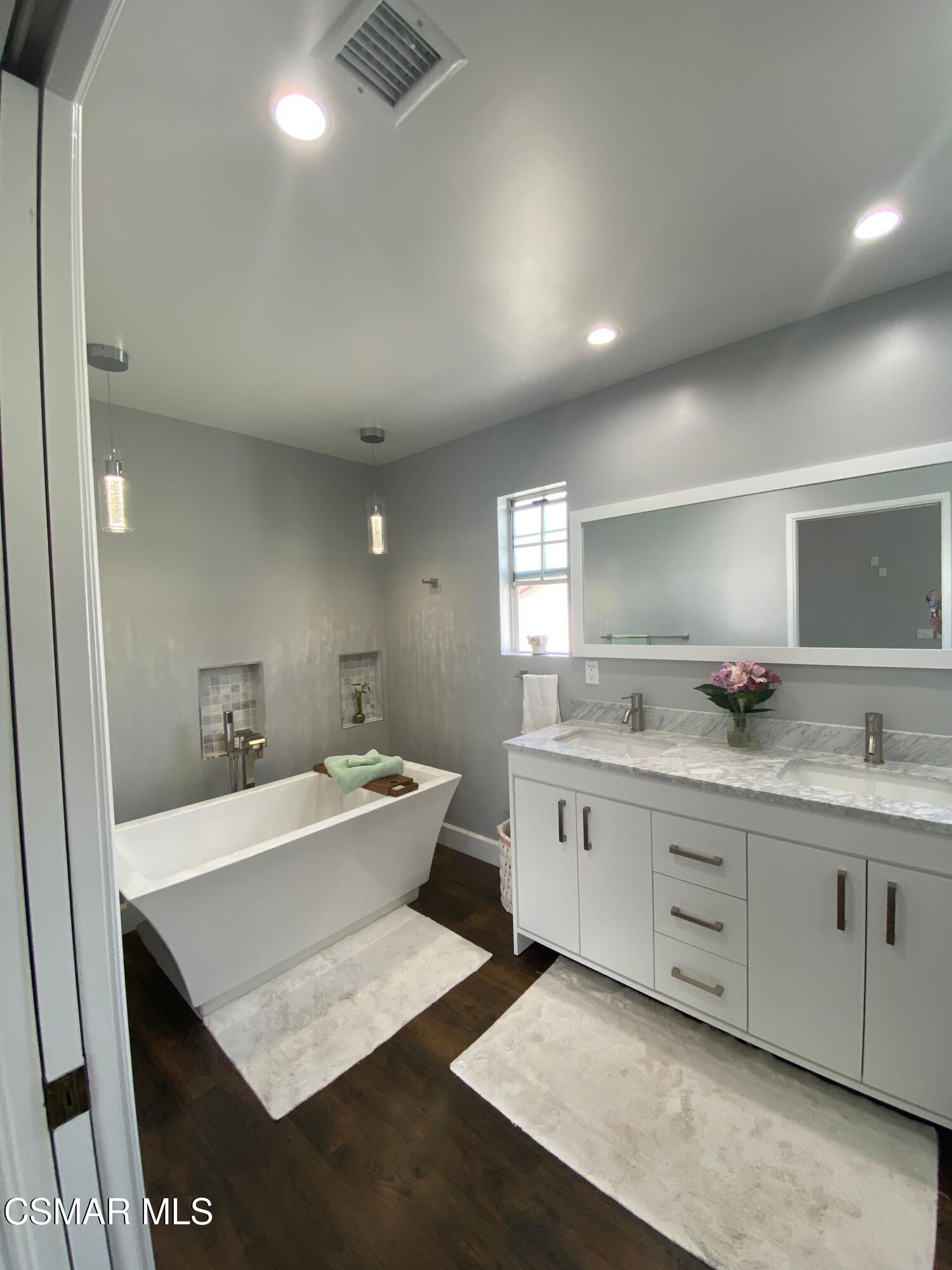 4511 Barnard Street Simi Valley, CA 93063 - Photo 21 of 25 a bathroom with a double vanity sink and mirror
