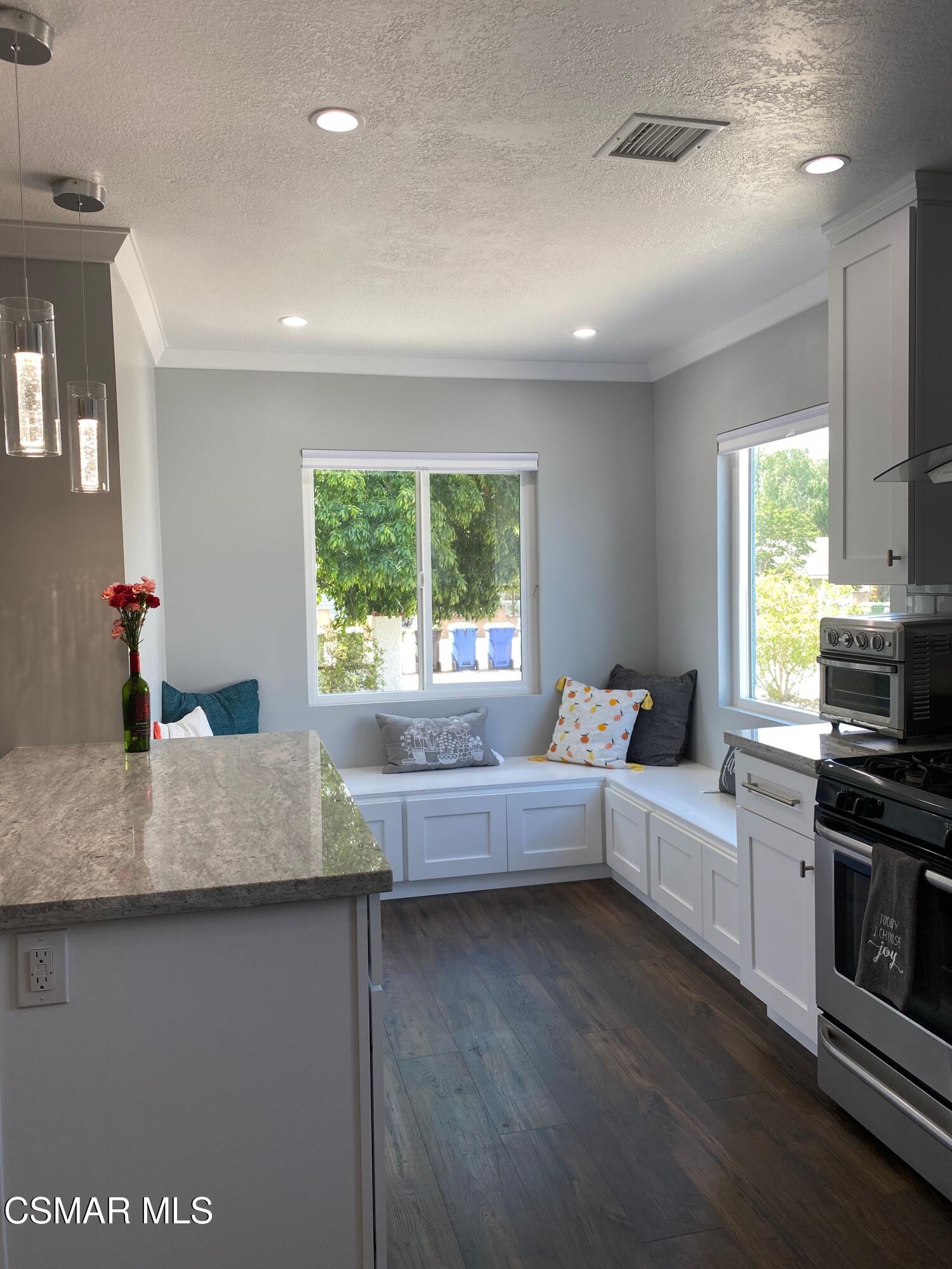 4511 Barnard Street Simi Valley, CA 93063 - Photo 3 of 25 a living room with kitchen island furniture and a fireplace