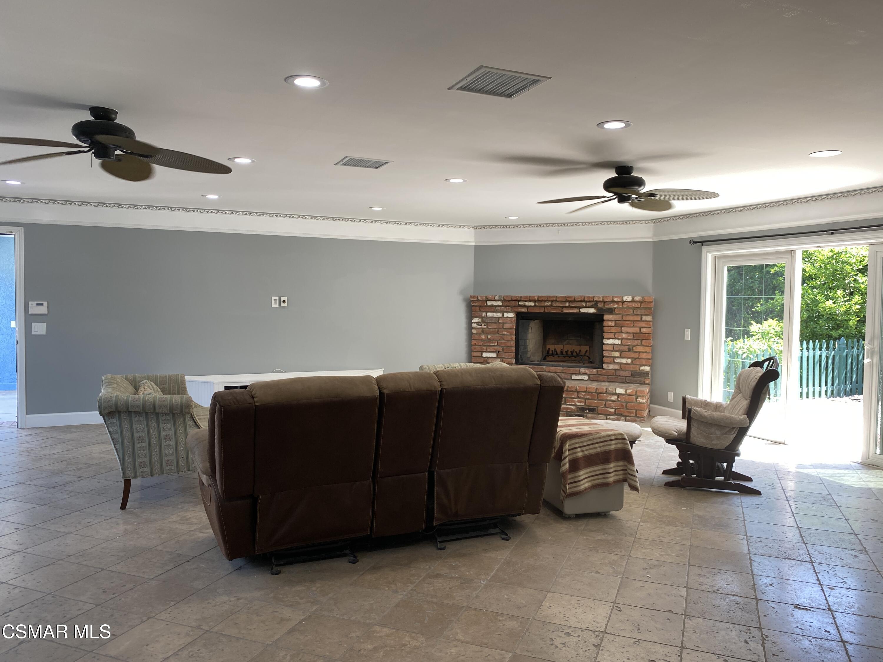 4511 Barnard Street Simi Valley, CA 93063 - Photo 7 of 25 a living room with furniture and a fireplace