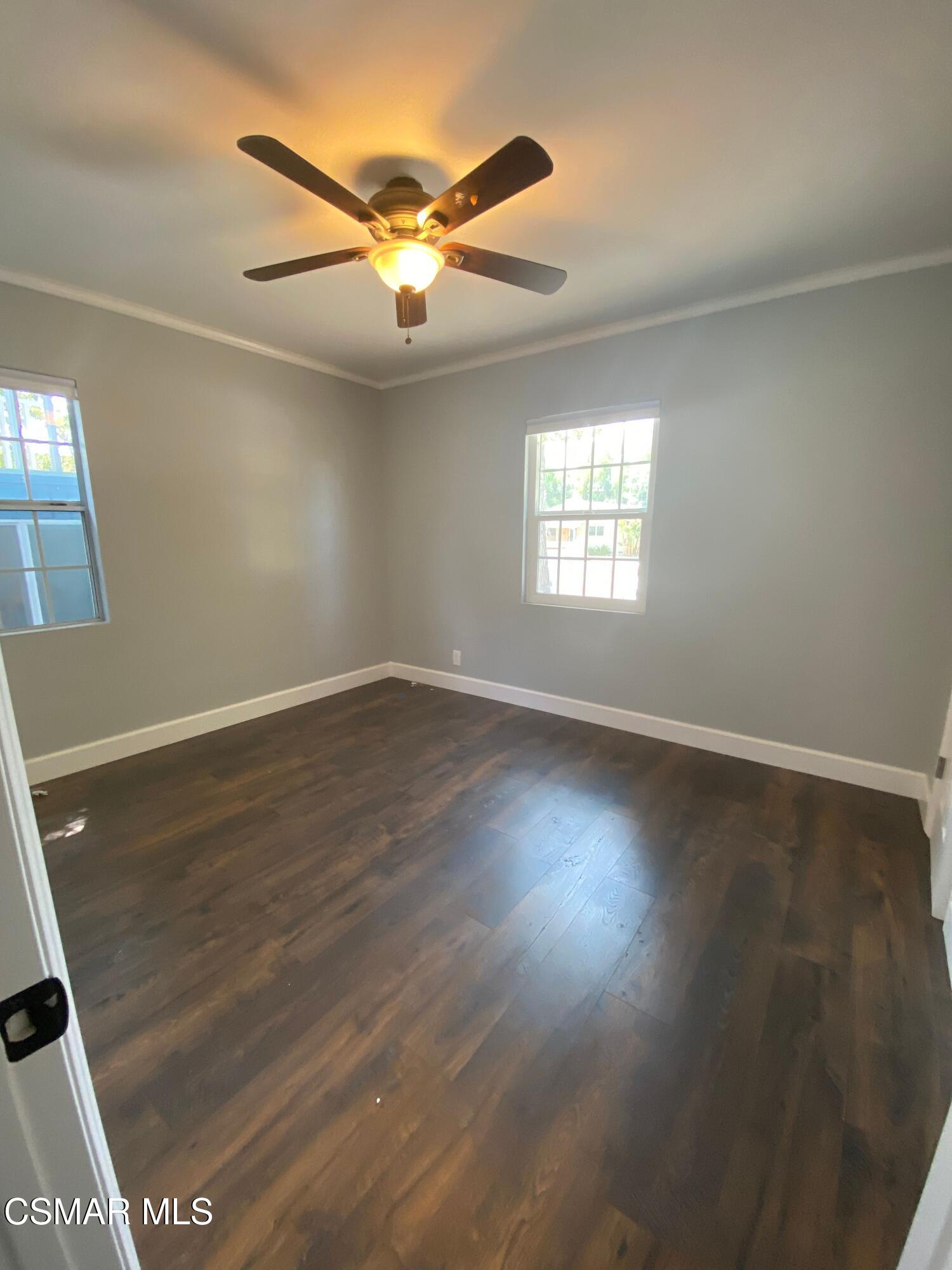 4511 Barnard Street Simi Valley, CA 93063 - Photo 9 of 25 an empty room with wooden floor and windows