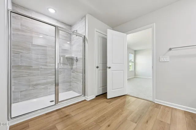 a bathroom with a glass shower door