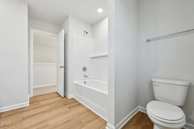 a bathroom with a toilet and a bathtub