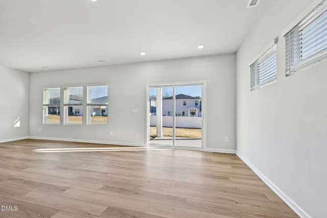 a view of large kitchen with wooden floor and a window