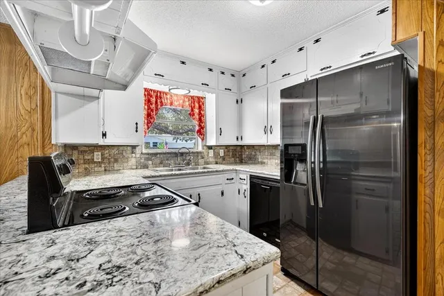 a kitchen with a refrigerator and a sink