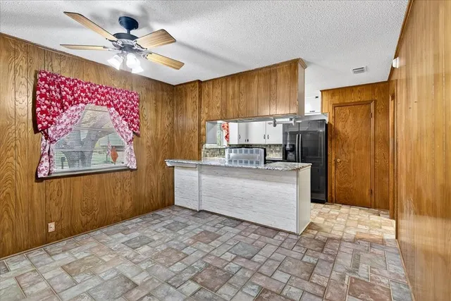a kitchen with cabinets and window