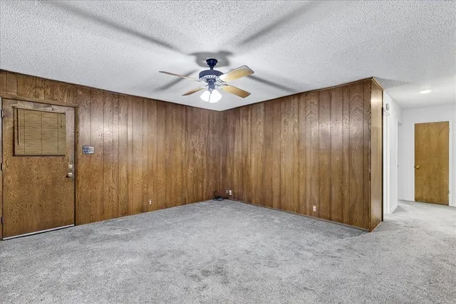 a view of an empty room with a ceiling fan