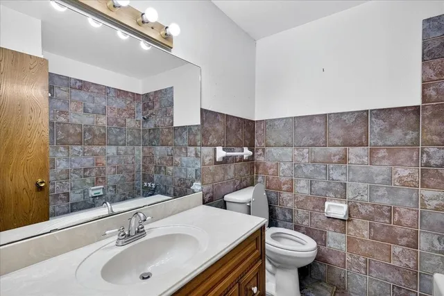 a bathroom with a sink toilet and a mirror