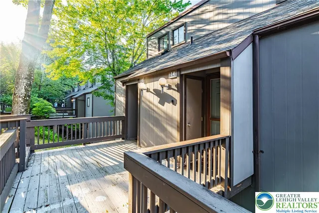 a view of balcony with wooden floor and fence