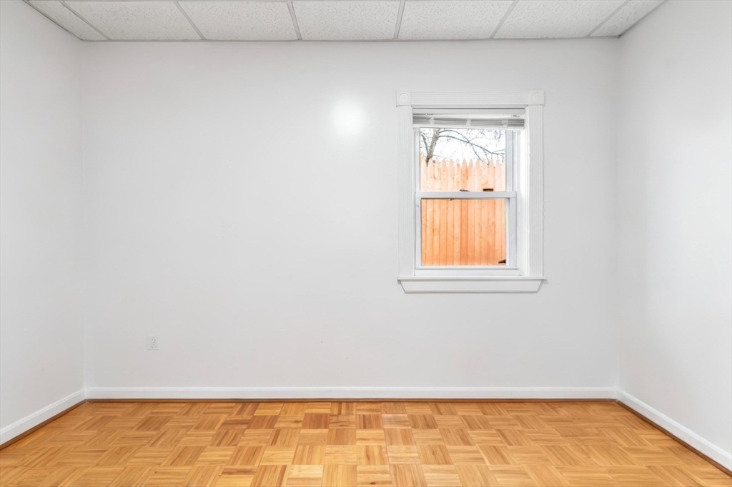 42 D Street Lowell, MA 01851 - Photo 20 of 27 a view of an empty room with wooden floor and a window