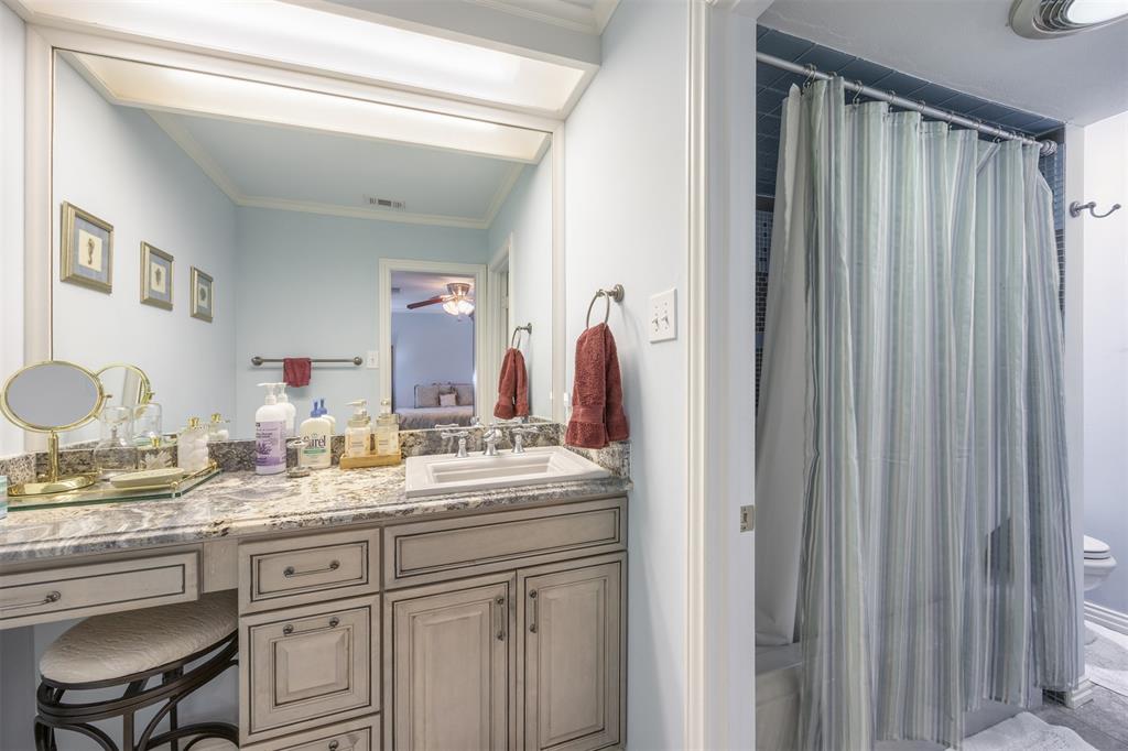 15615 Preston Road, Unit 1010 Dallas, TX 75248 - Photo 28 of 40 Left side of Jack & Jill Bathroom. Custom vanity, granite top, high end sink and faucets. Entrance door to fully renovated bathtub/shower, tile and toilet room.