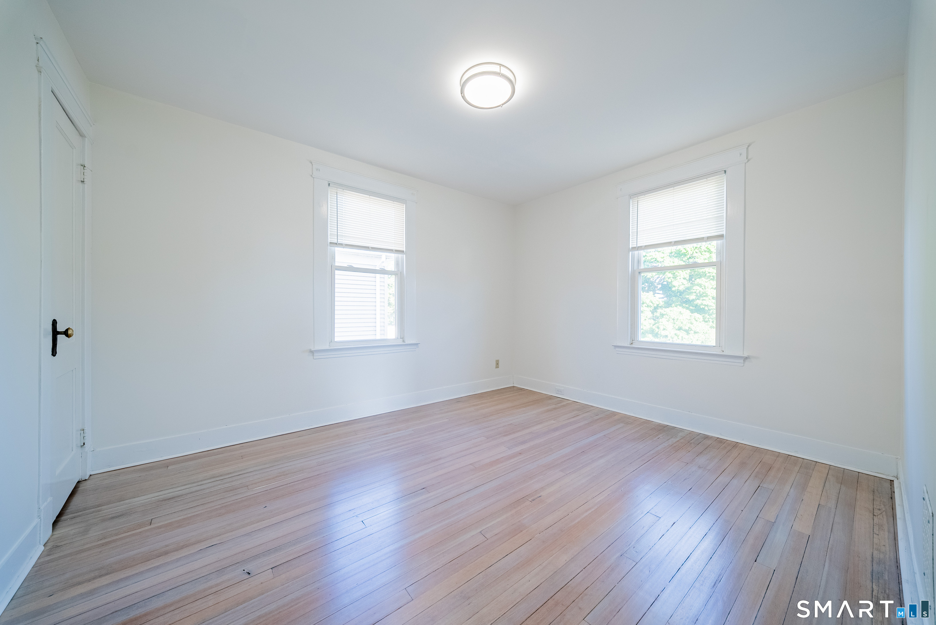 50 Jones Street West Haven, CT 06516 - Photo 12 of 21 an empty room with wooden floor and windows