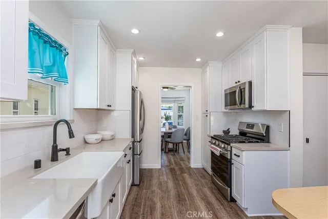 a kitchen with stainless steel appliances a sink stove and refrigerator