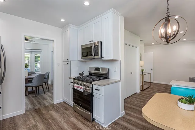 a kitchen with a stove a sink and a microwave