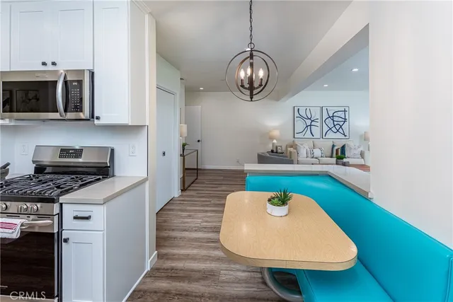 a kitchen with stainless steel appliances granite countertop a sink a stove and a microwave