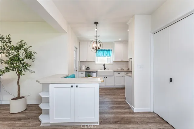 a kitchen with a sink and a stove top oven