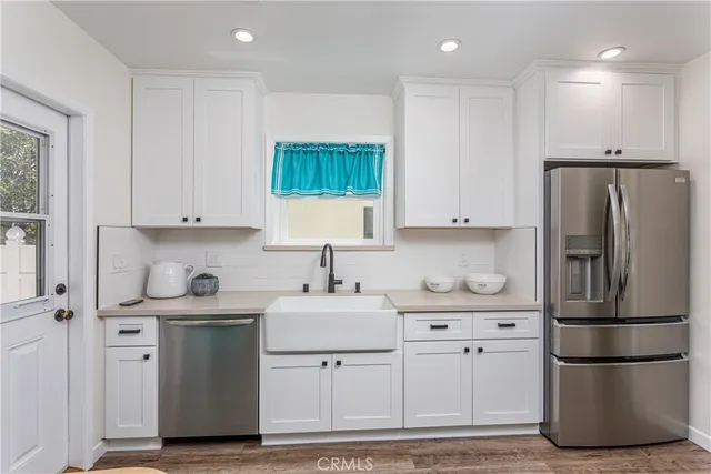 a kitchen with stainless steel appliances a refrigerator sink and cabinets