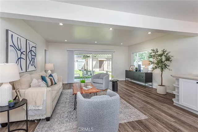 a living room with furniture and a potted plant