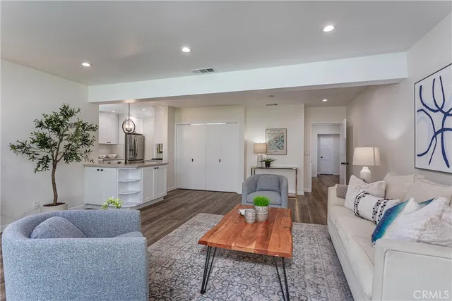 a living room with furniture and a potted plant