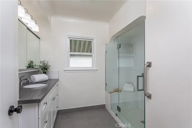a bathroom with a shower sink and toilet