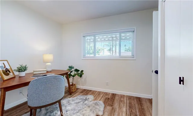 a workspace room with furniture and wooden floor