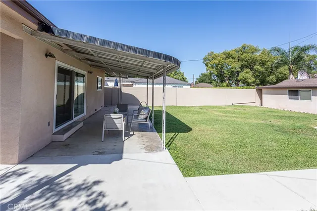 a view of a patio with table and chairs with wooden floor and fence