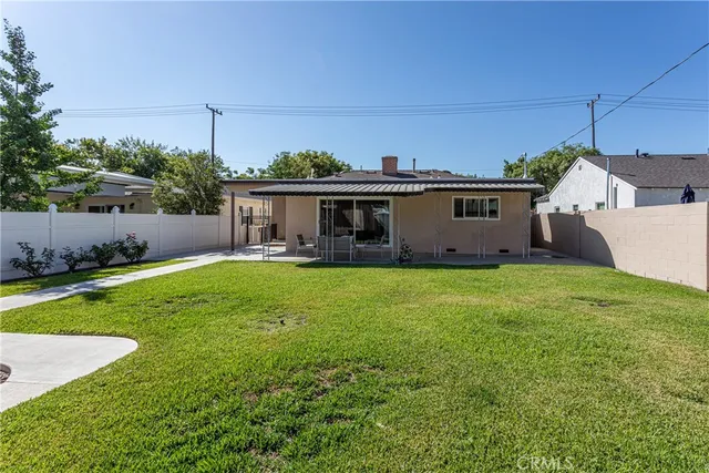 a view of a house with pool and a yard