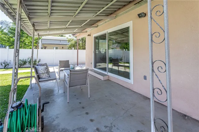 a view of a chairs and table in patio