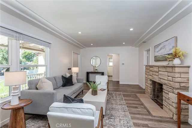 a living room with furniture a fireplace and a table