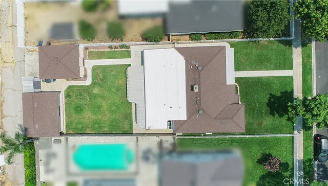 an aerial view of a house with a yard and lake view