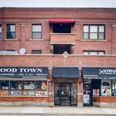a view of a food market with retail stalls