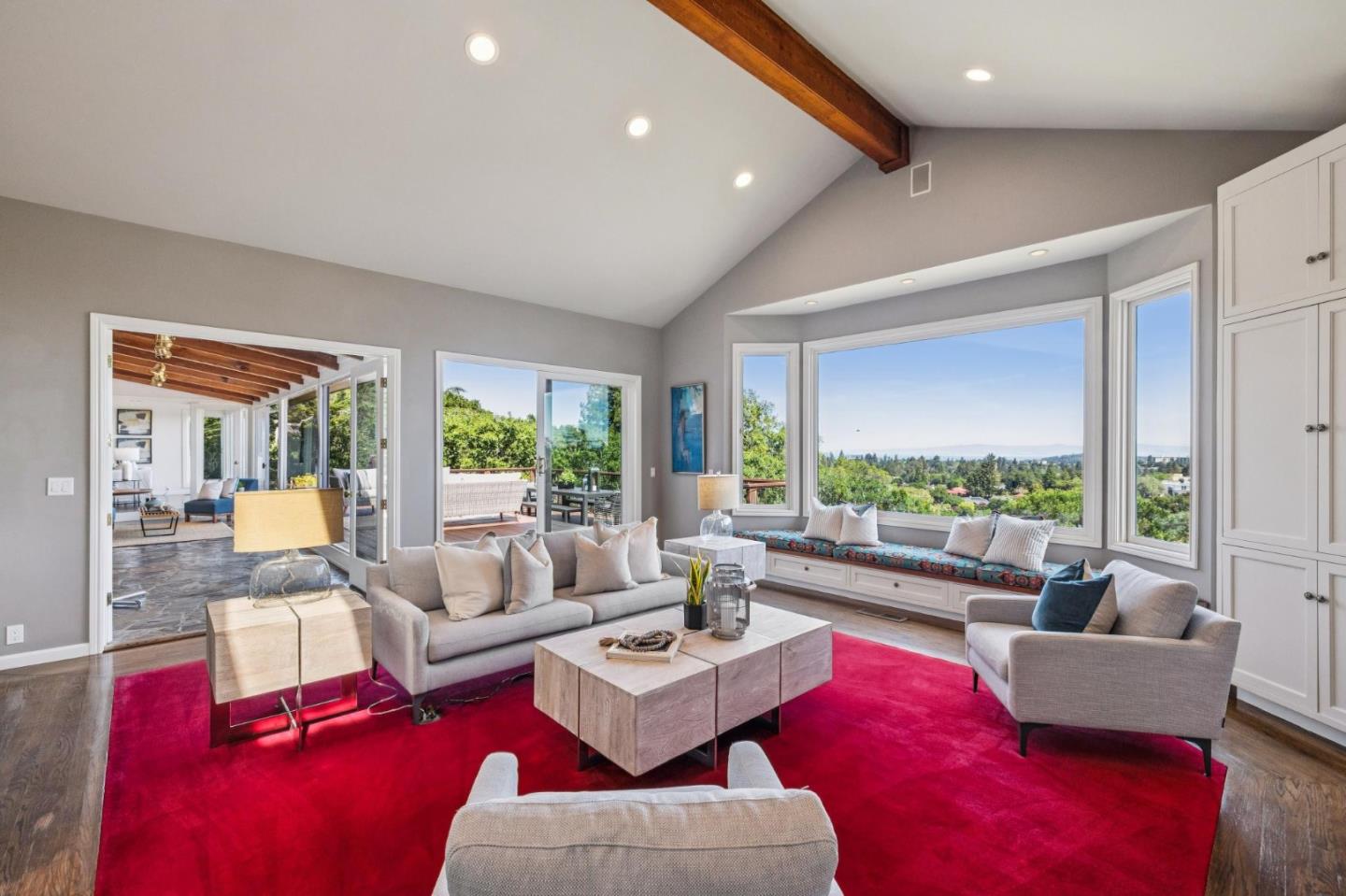 720 Endfield Way Hillsborough, CA 94010 - Photo 16 of 76 a living room with furniture floor to ceiling windows and a table