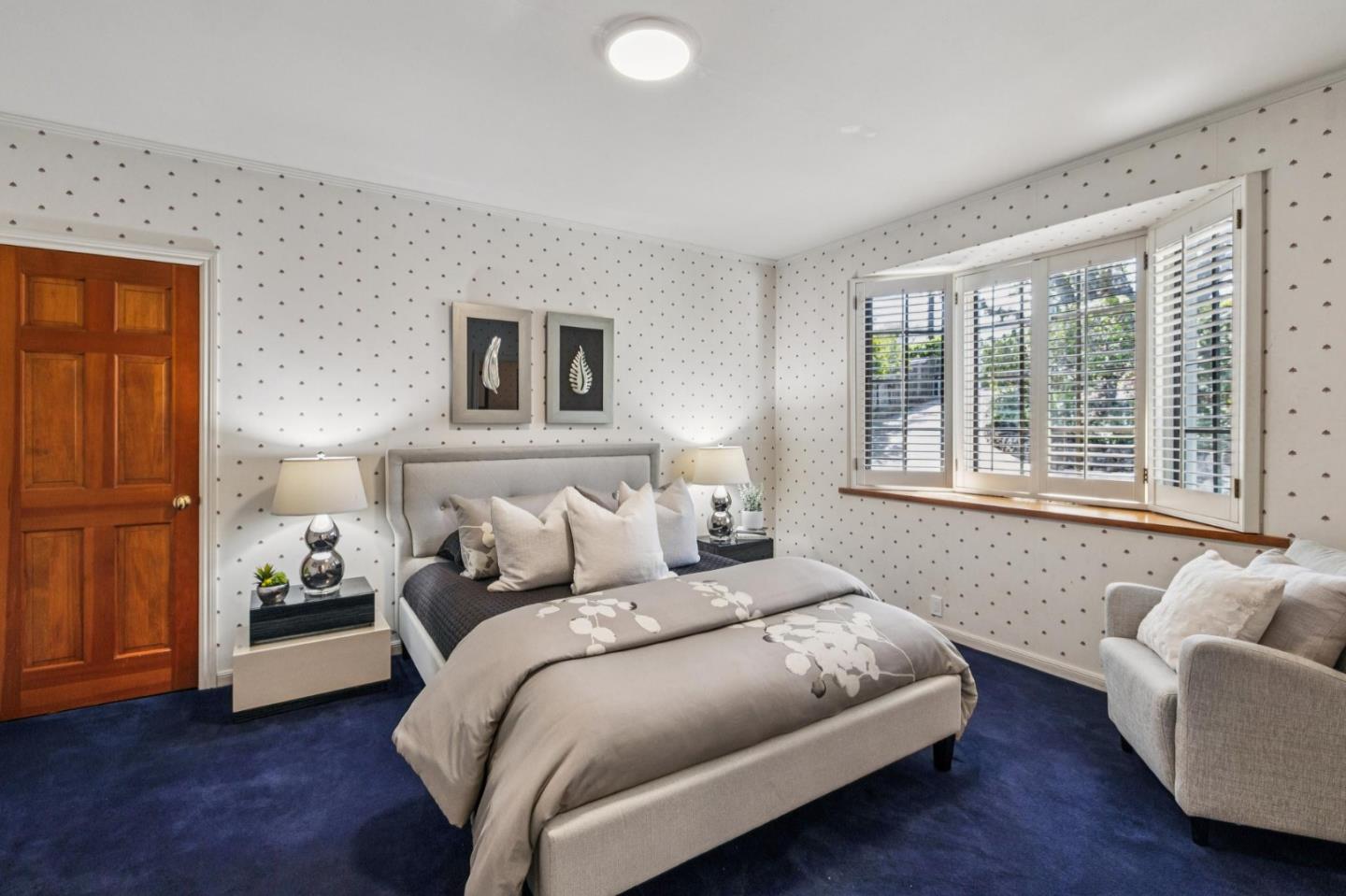 720 Endfield Way Hillsborough, CA 94010 - Photo 46 of 76 a bedroom with a bed and a couch with wooden floor