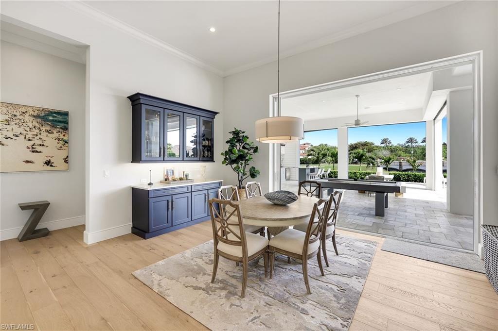 16415 Seneca Way Naples, FL 34110 - Photo 13 of 50 a view of a dining room with furniture window and wooden floor