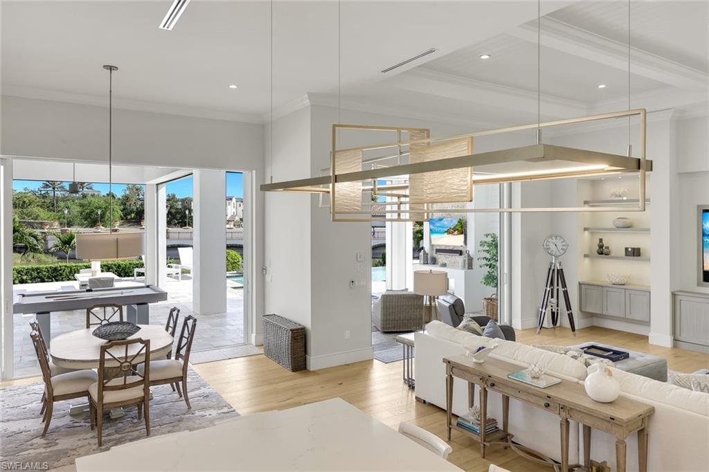 16415 Seneca Way Naples, FL 34110 - Photo 14 of 50 a dining room with furniture a chandelier and window