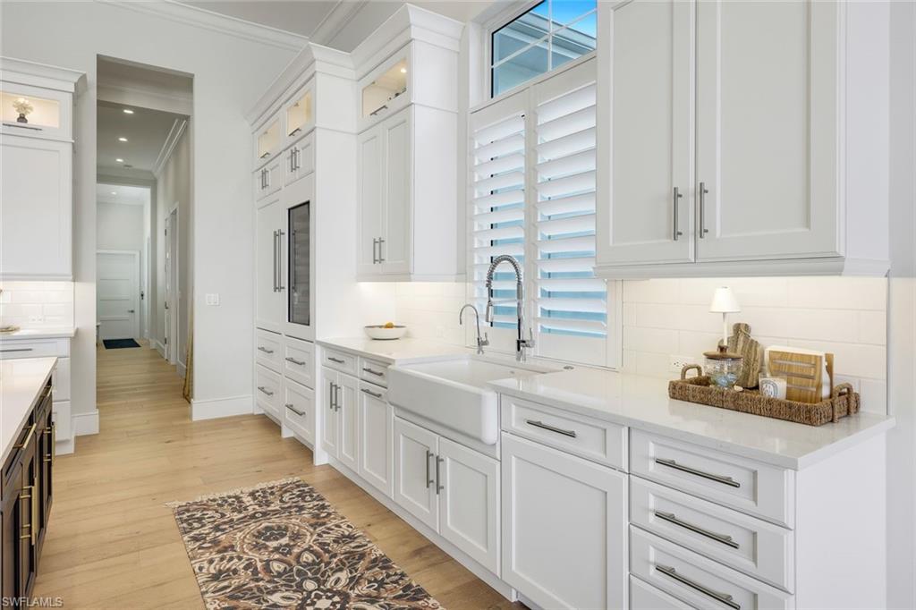 16415 Seneca Way Naples, FL 34110 - Photo 20 of 50 a kitchen with cabinets and sink
