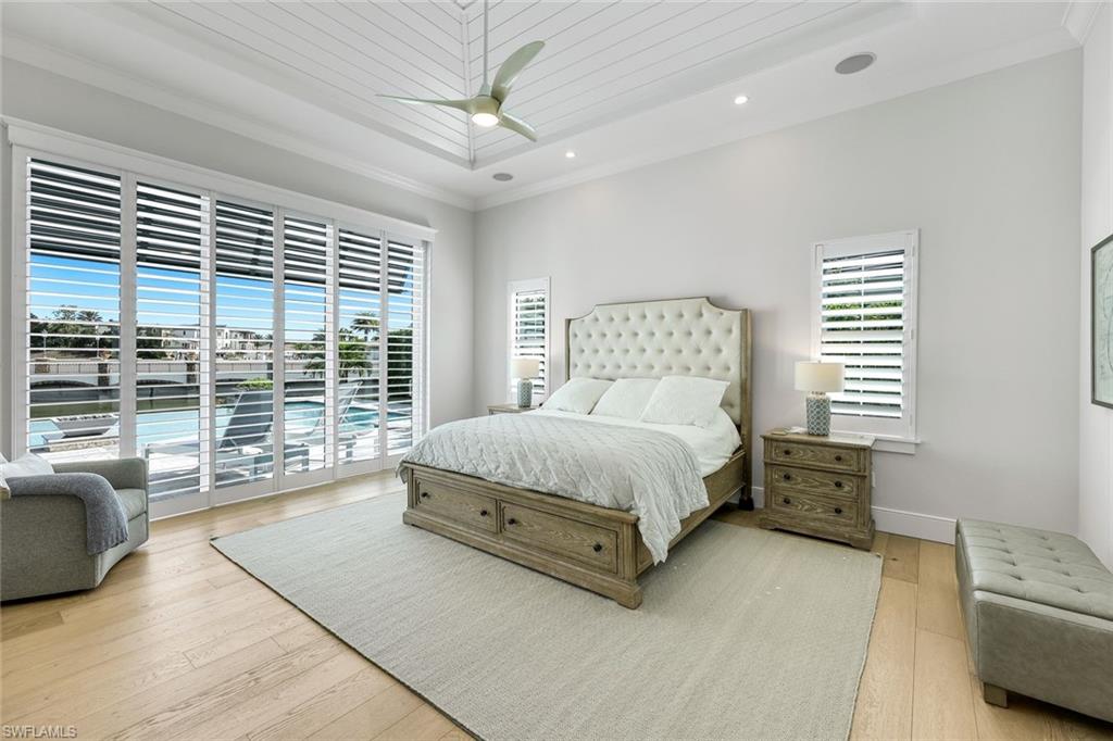 16415 Seneca Way Naples, FL 34110 - Photo 25 of 50 a bedroom with a large bed and a couch