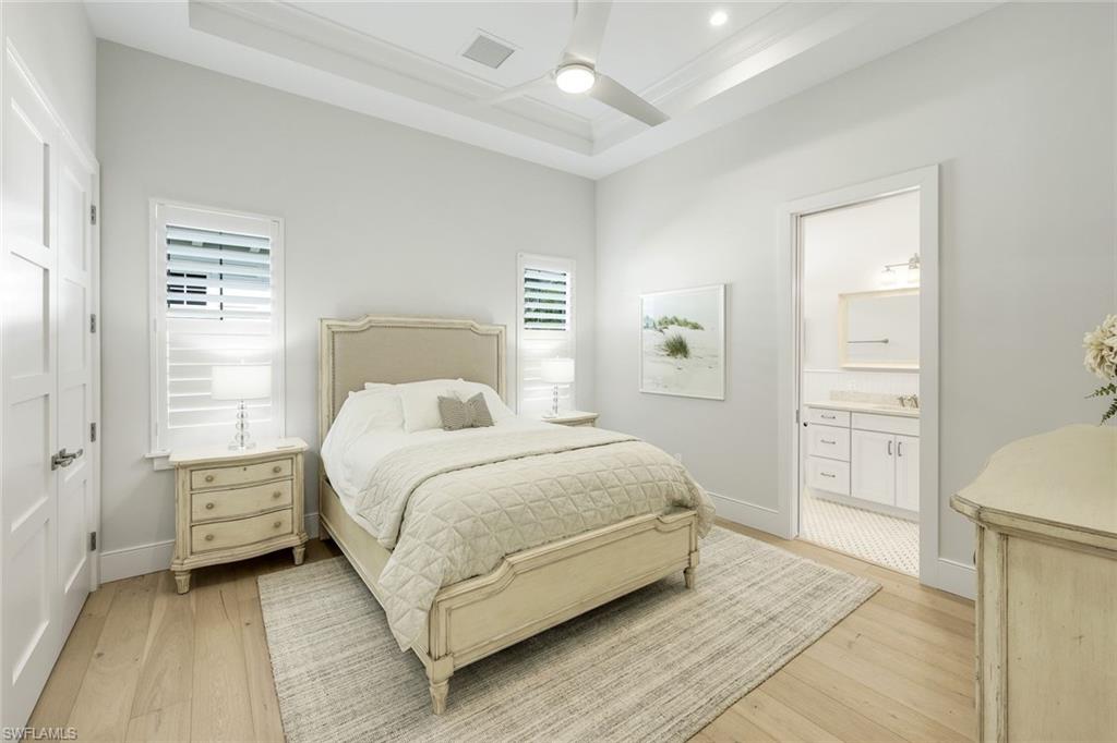 16415 Seneca Way Naples, FL 34110 - Photo 28 of 50 a bedroom with a bed and a cabinets