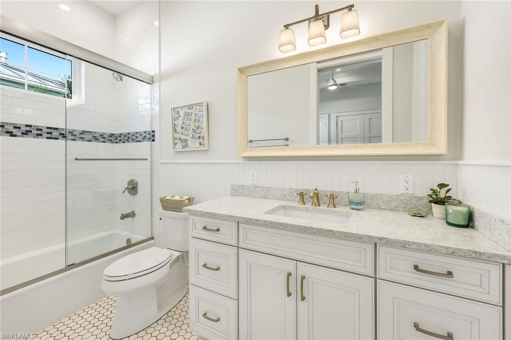 16415 Seneca Way Naples, FL 34110 - Photo 29 of 50 a bathroom with a granite countertop toilet sink and a mirror