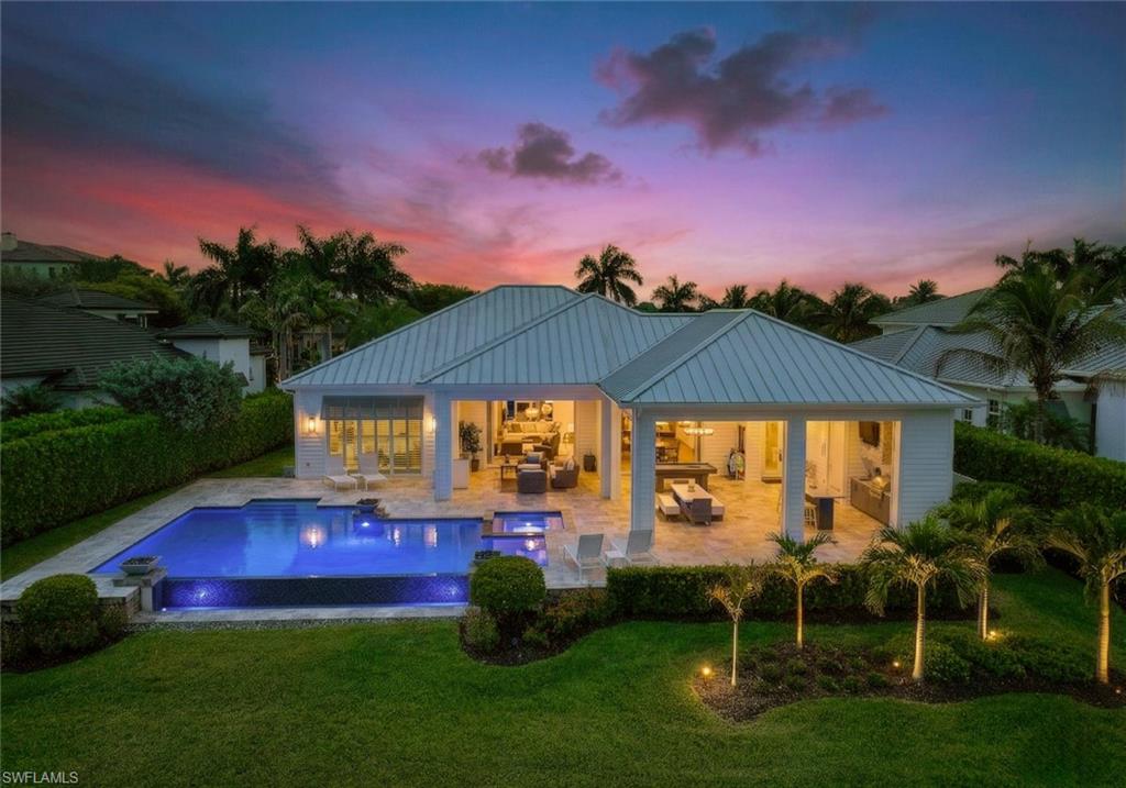 16415 Seneca Way Naples, FL 34110 - Photo 3 of 50 an outdoor sitting area with swimming pool and fire pit