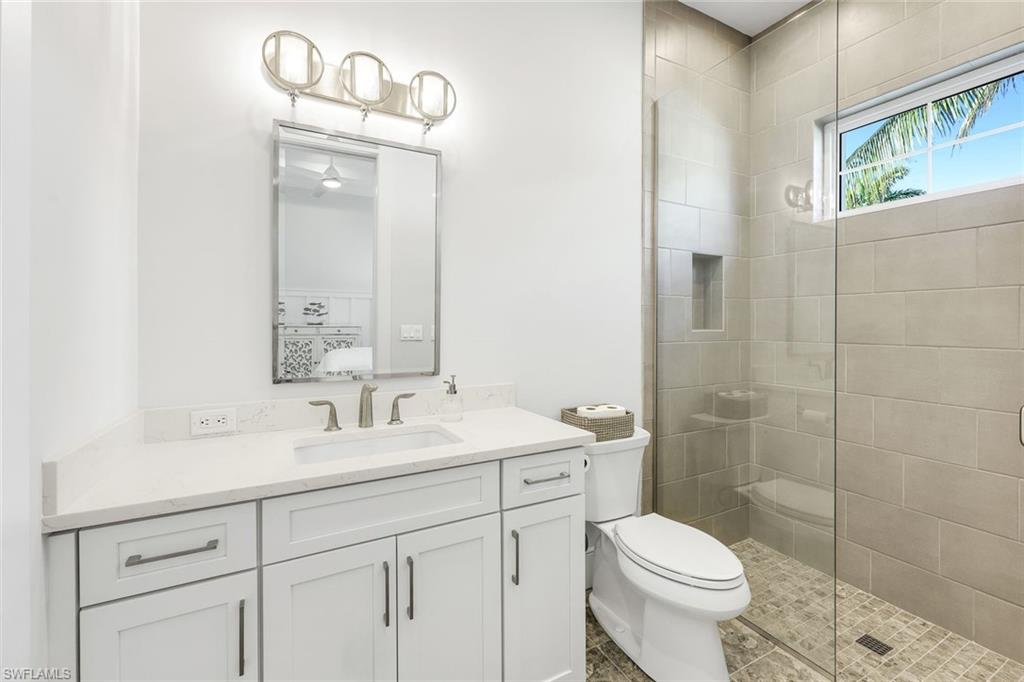 16415 Seneca Way Naples, FL 34110 - Photo 31 of 50 a bathroom with a sink a toilet and shower