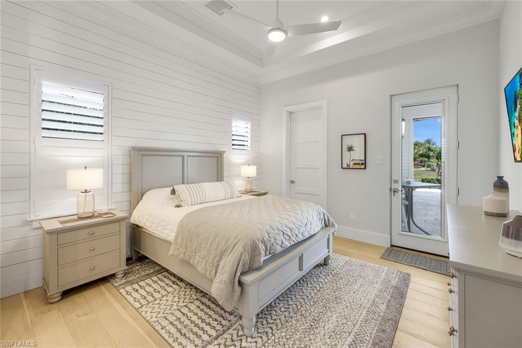 16415 Seneca Way Naples, FL 34110 - Photo 32 of 50 a bedroom with a bed and a view of bathroom