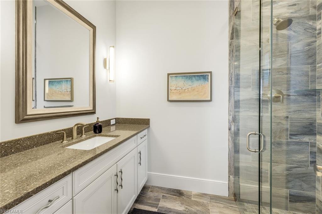 16415 Seneca Way Naples, FL 34110 - Photo 33 of 50 a bathroom with a granite countertop sink and a mirror